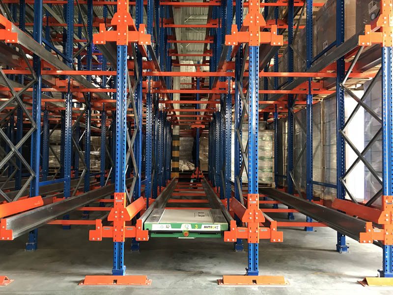 Live pallet racking system with inclined roller lanes for FIFO stock rotation