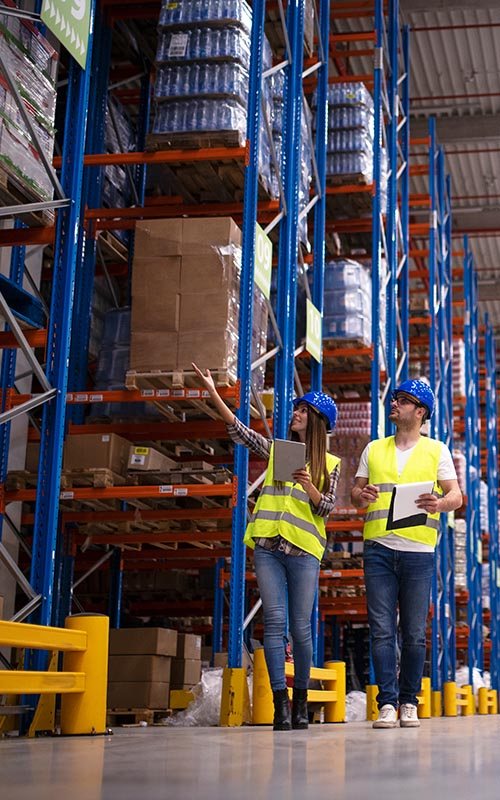 Interior view of a warehouse with tall pallet racking illustrating vertical storage capacity
